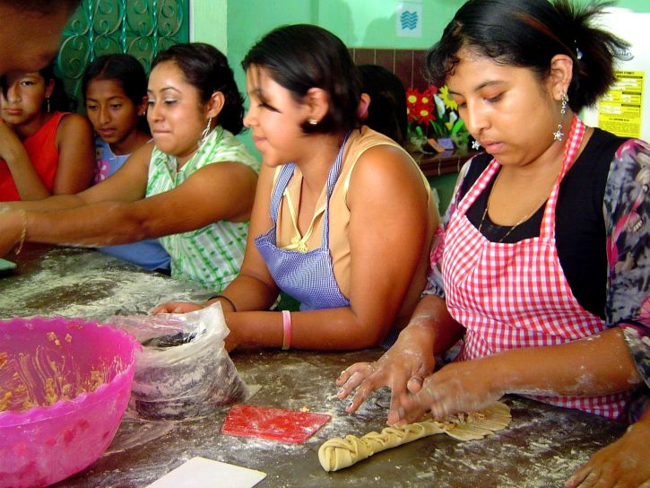 Latina women cooking together.